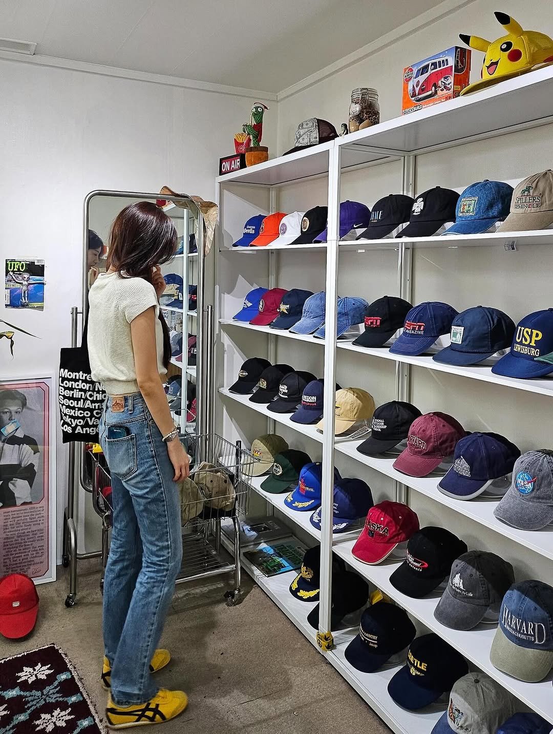 Photo by 장규리 on September 08, 2025. May be an image of hat, rack, clothes hanger, hat shop and text.