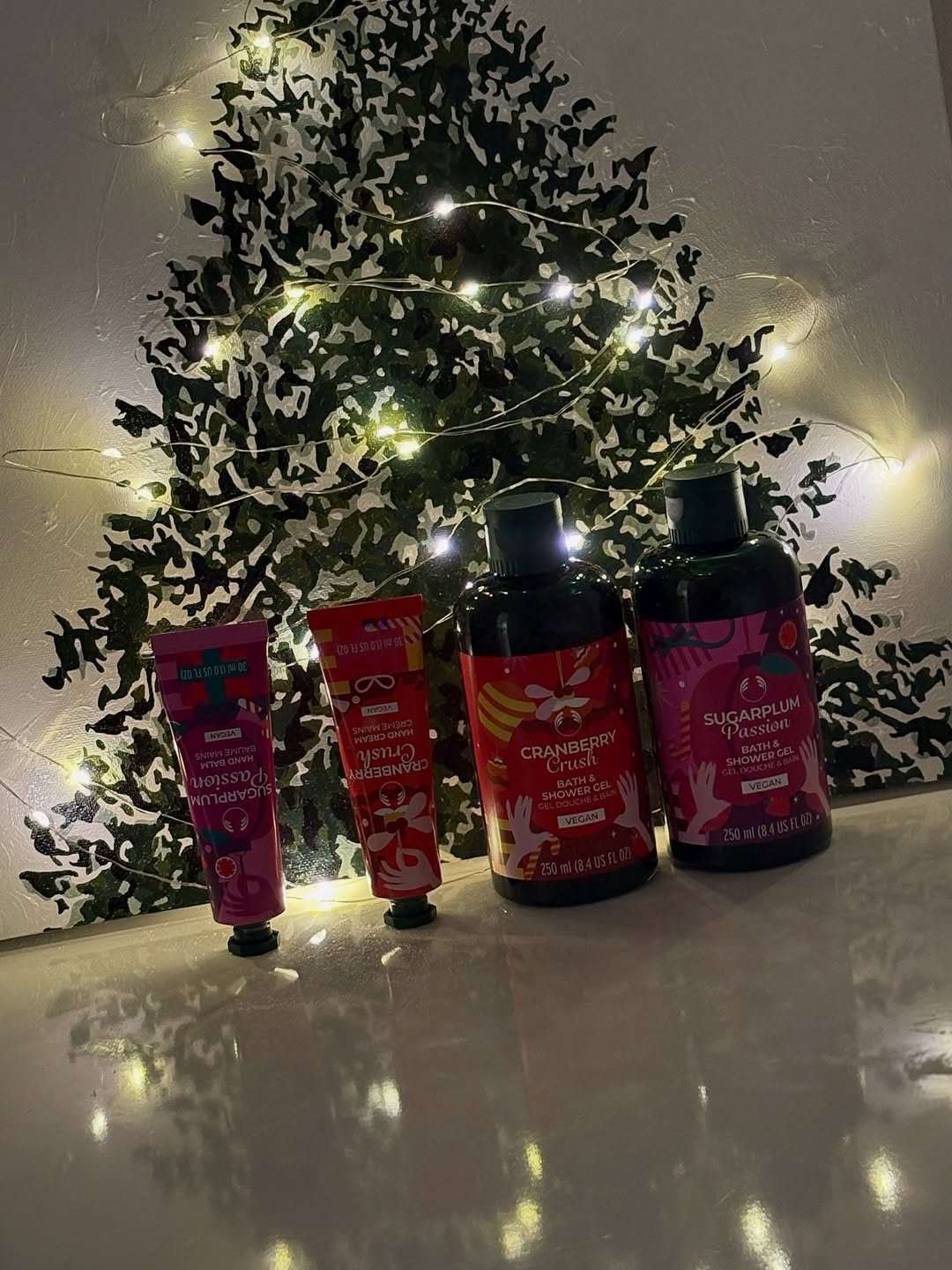 Photo shared by 흿 on November 12, 2025 tagging @thebodyshop_korea. May be an image of christmas tree, fragrance, hair product, hand cream, tinsel and text.