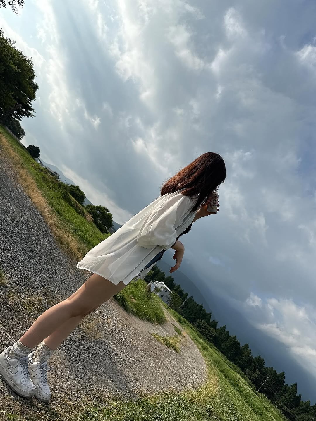 Photo by ヒ ビ キ on July 09, 2025. May be an image of 1 person, cloud, road, grass and text.