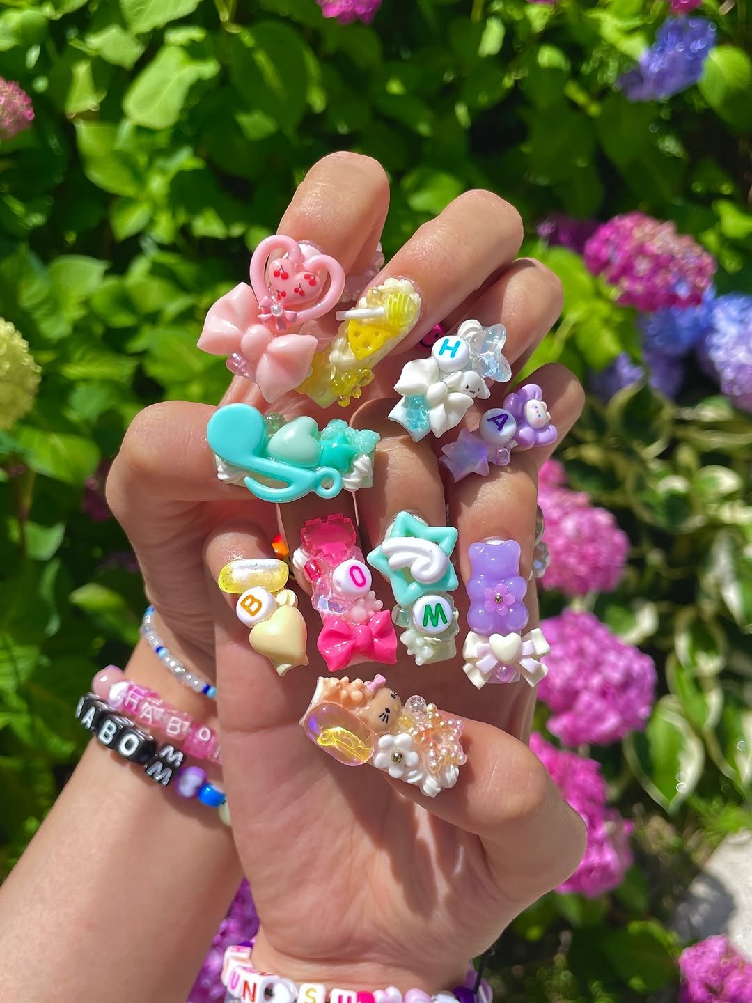 Photo by 하봄 on June 19, 2025. May be an image of one or more people, fingernails, owl, barrette and text.