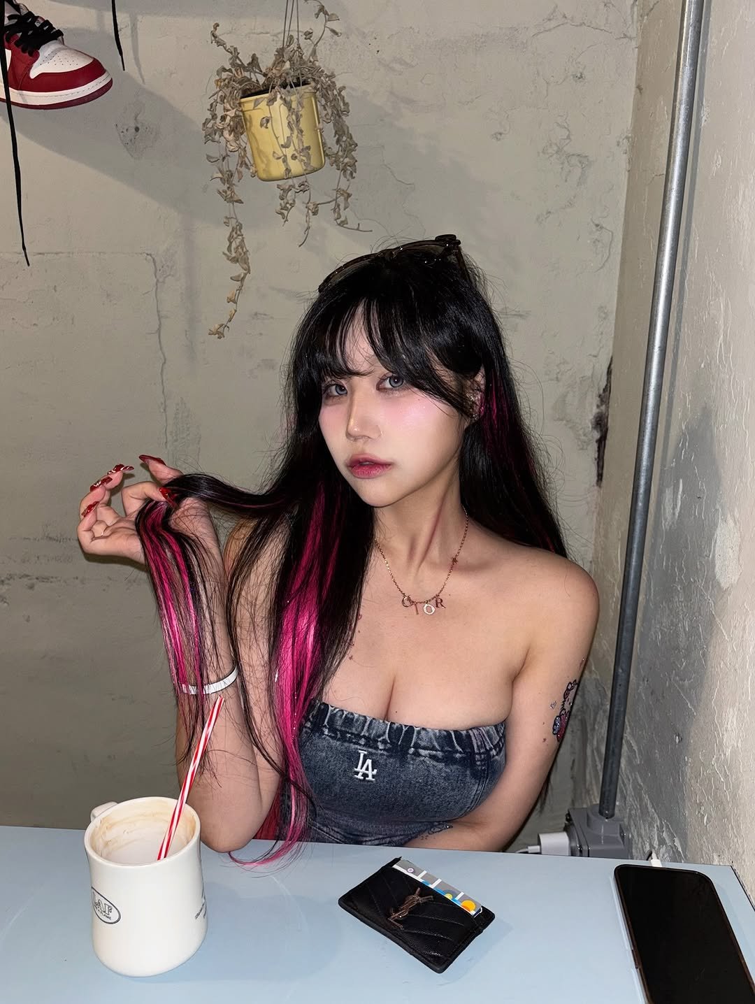Photo by 해봄 on September 15, 2025. May be an image of 1 person, hair, fishnet stockings, bra and text.