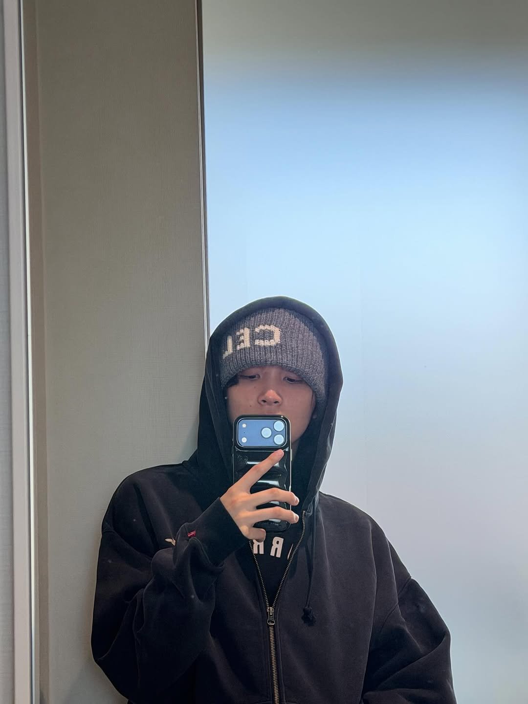 Photo by HAECHAN on March 07, 2026. May be a selfie of phone, duffle coat, jacket, fleece, parka, sweatshirt, face mask, sweatpants, mirror and text.