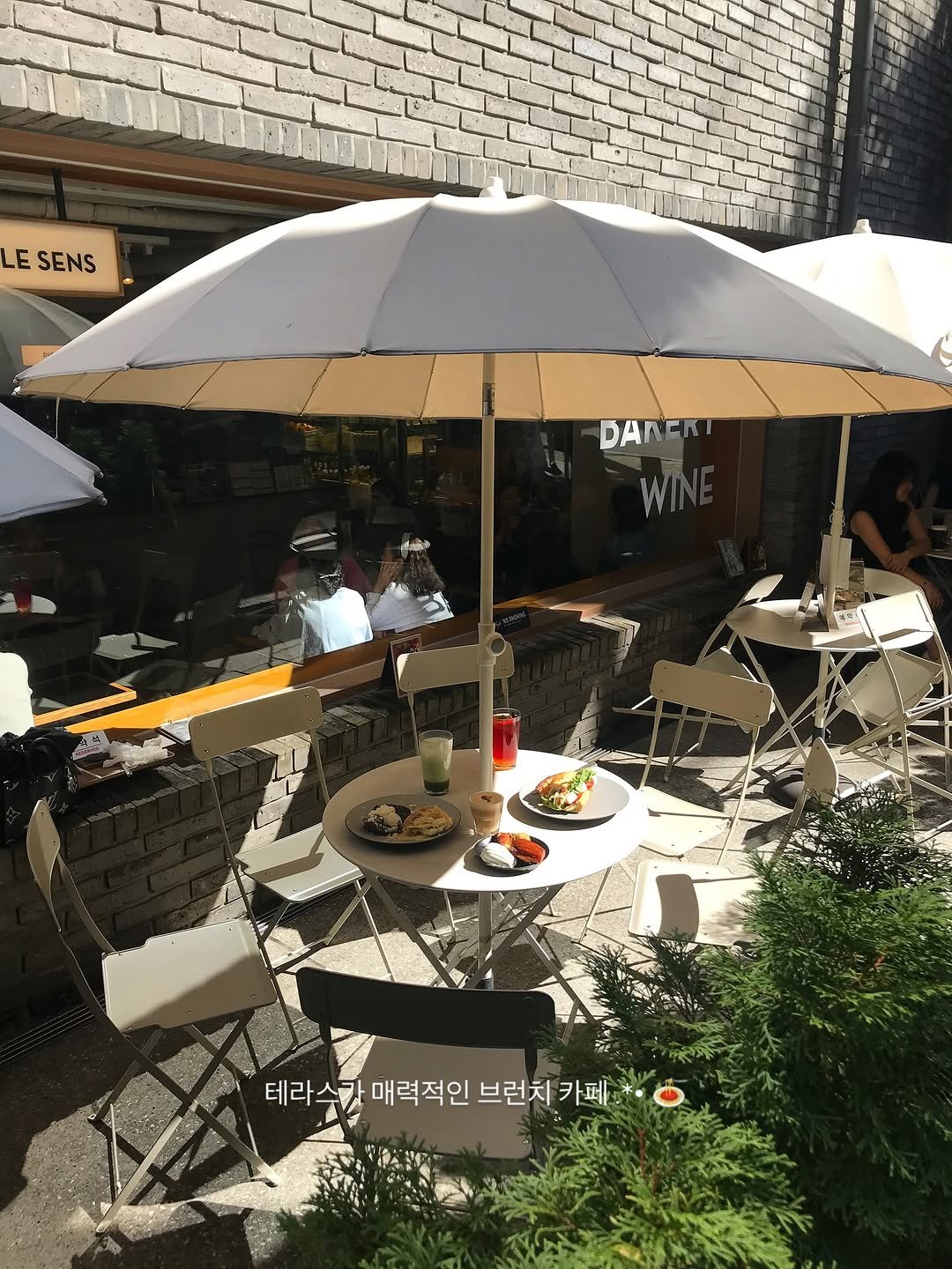 Photo shared by 한 컾 | 카페 • Cafe on September 25, 2025 tagging @cafelesens. May be an image of 2 people, parasol, umbrella and text.