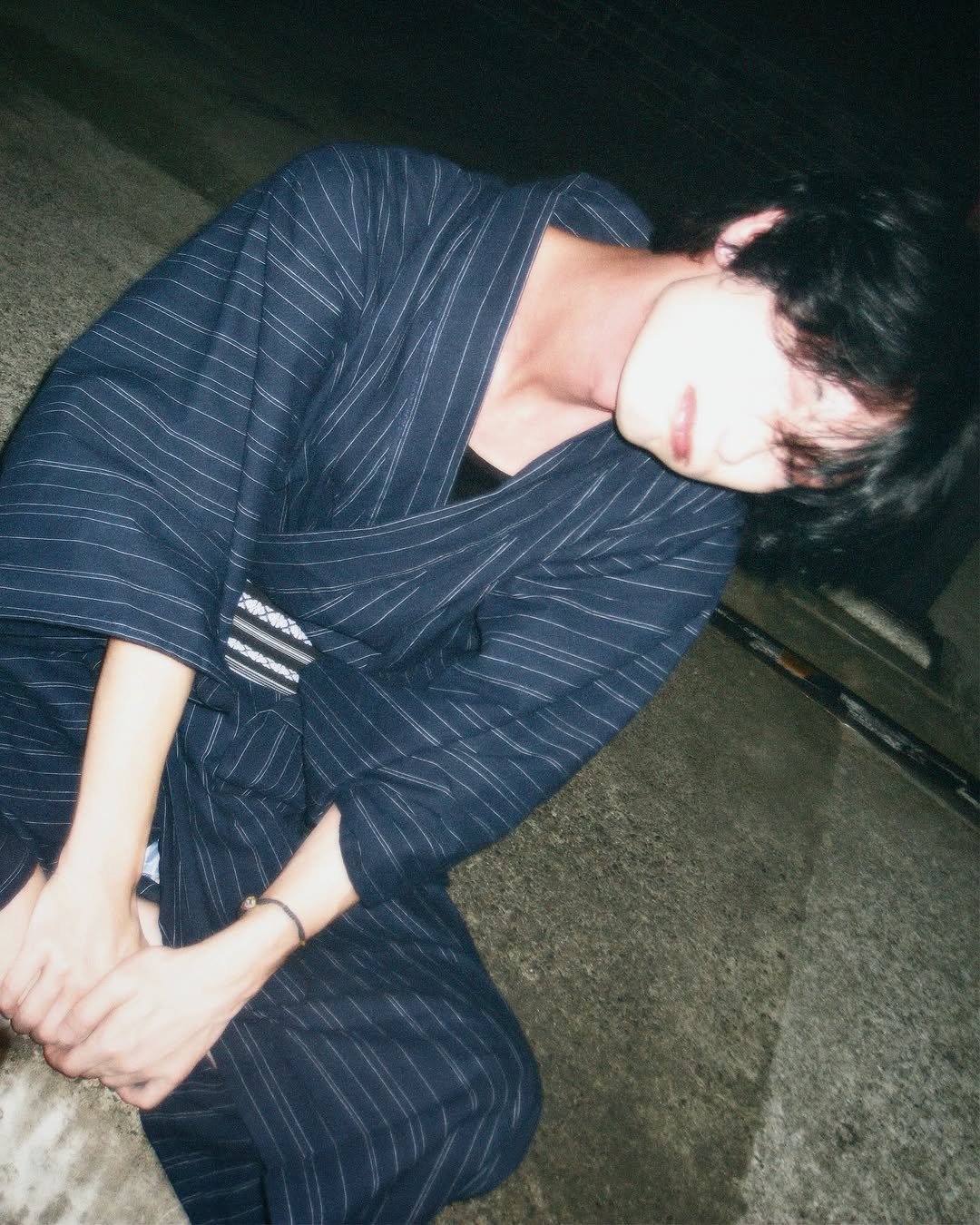 Photo by 승한•スンハン on August 05, 2025. May be an image of 1 person, sleeping, bath robe, cigarette, robe and text.