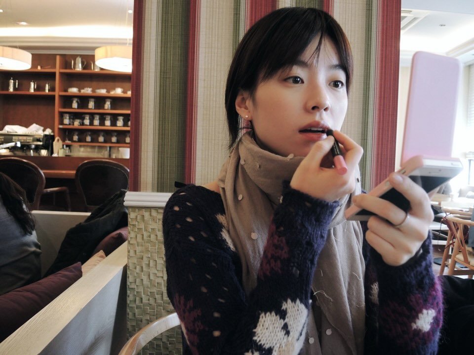 Photo shared by Hanhyojoo on January 25, 2026 tagging @hyunbeenshin. May be an image of one or more people, lipstick, duffle coat, phone, turtleneck, cigarette and text.