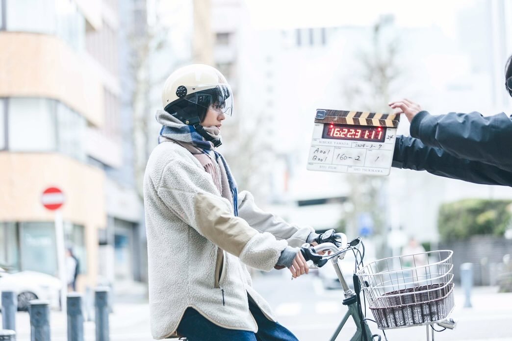 Photo by Hanhyojoo on November 03, 2025. May be an image of one or more people, duffle coat, top, street and text.