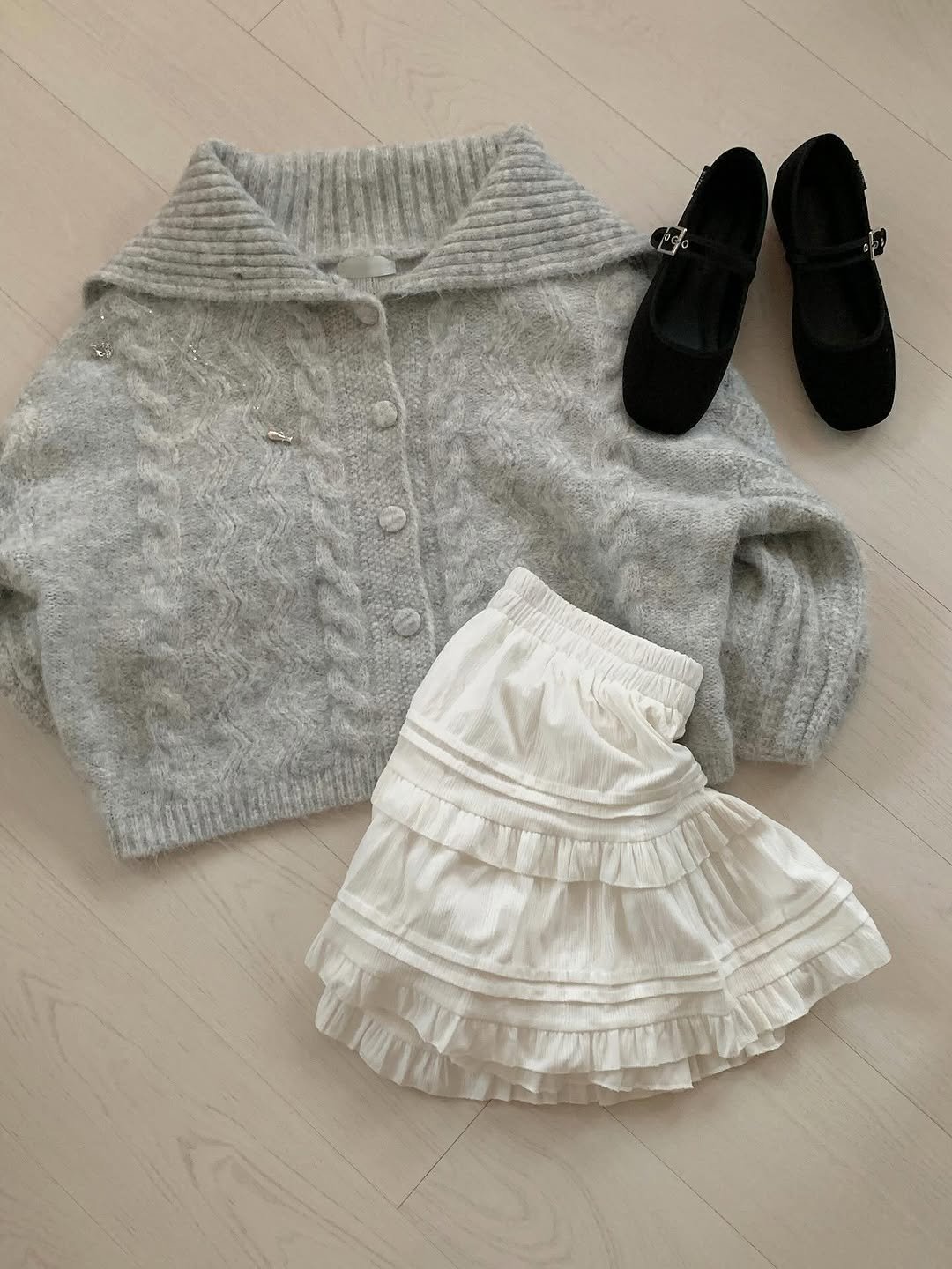 Photo shared by 수빈 on October 23, 2025 tagging @differshoe_official. May be an image of sweater, skirt, cardigan, knit and text.