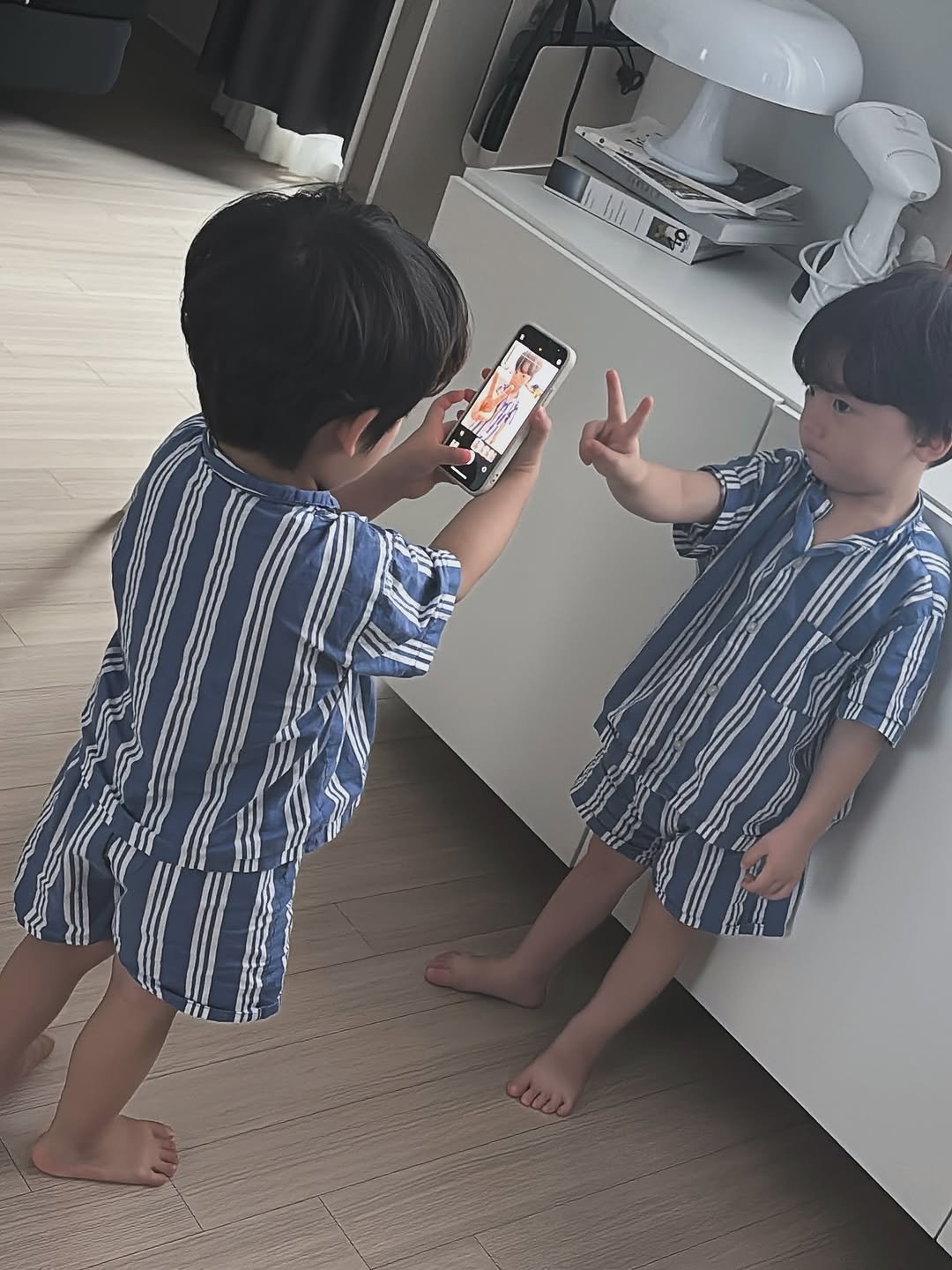 Photo by 💍 ＋👶🏻👶🏻 on August 29, 2025. May be an image of 2 people, baby, phone, sleepwear, bath robe, tablet, cornflower and text.