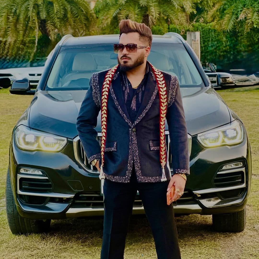 Photo by 👑𝐇𝐀𝐑𝐒𝐇𝐈𝐓 🦁 𝐁𝐇𝐀𝐓𝐈𝐀👑 on February 17, 2026. May be an image of one or more people, beard, people standing, car, wrist watch, suit, sunglasses, blazer, outdoors and text.