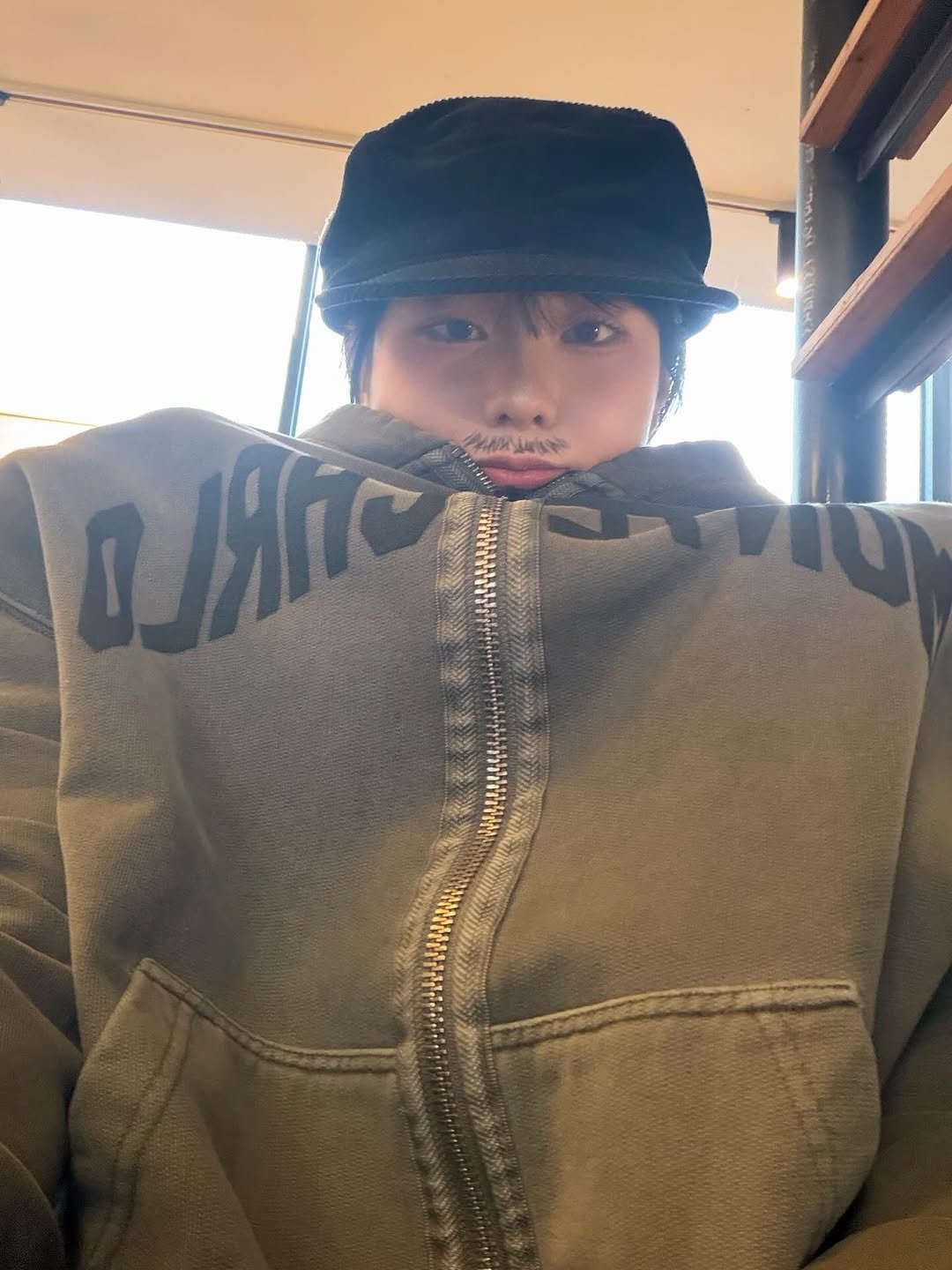 Photo by 고로켓 on February 20, 2026. May be an image of hat, duffle coat, parka, sweatshirt, jacket and text.