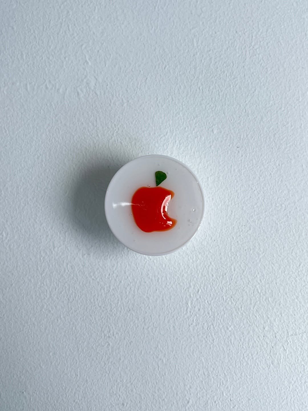 Photo by heloki 헤로키 on August 08, 2025. May be an image of apple, button, brooch, paper weight, belt buckle and text.