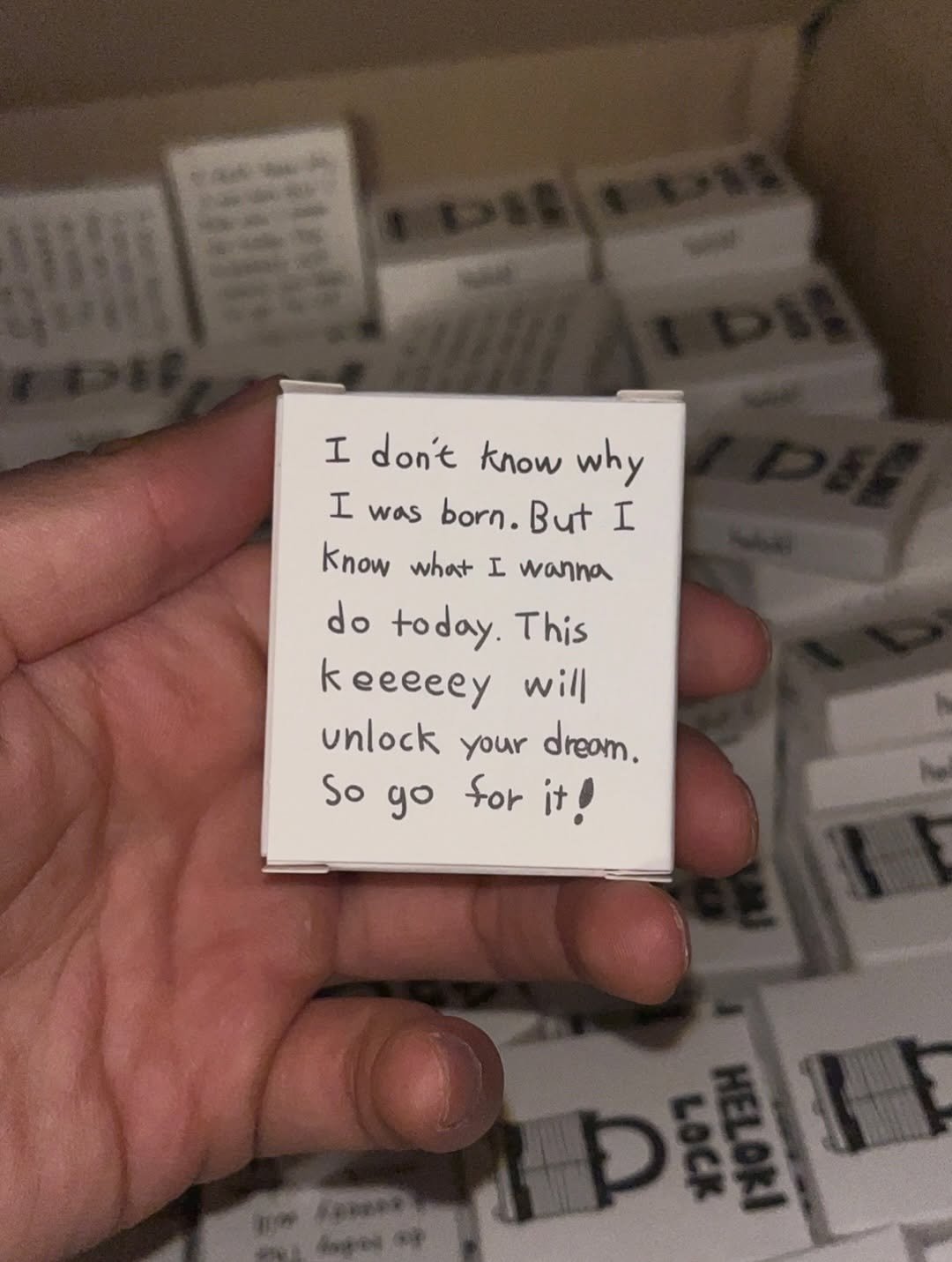 Photo by heloki 헤로키 on December 21, 2025. May be an image of matchbook, box, paper weight, bar soap, soap and text that says 'I don't know why I was born. But I Know what I wanna do today This keeeeey will unlock your dream. So 우아 it go 調'.