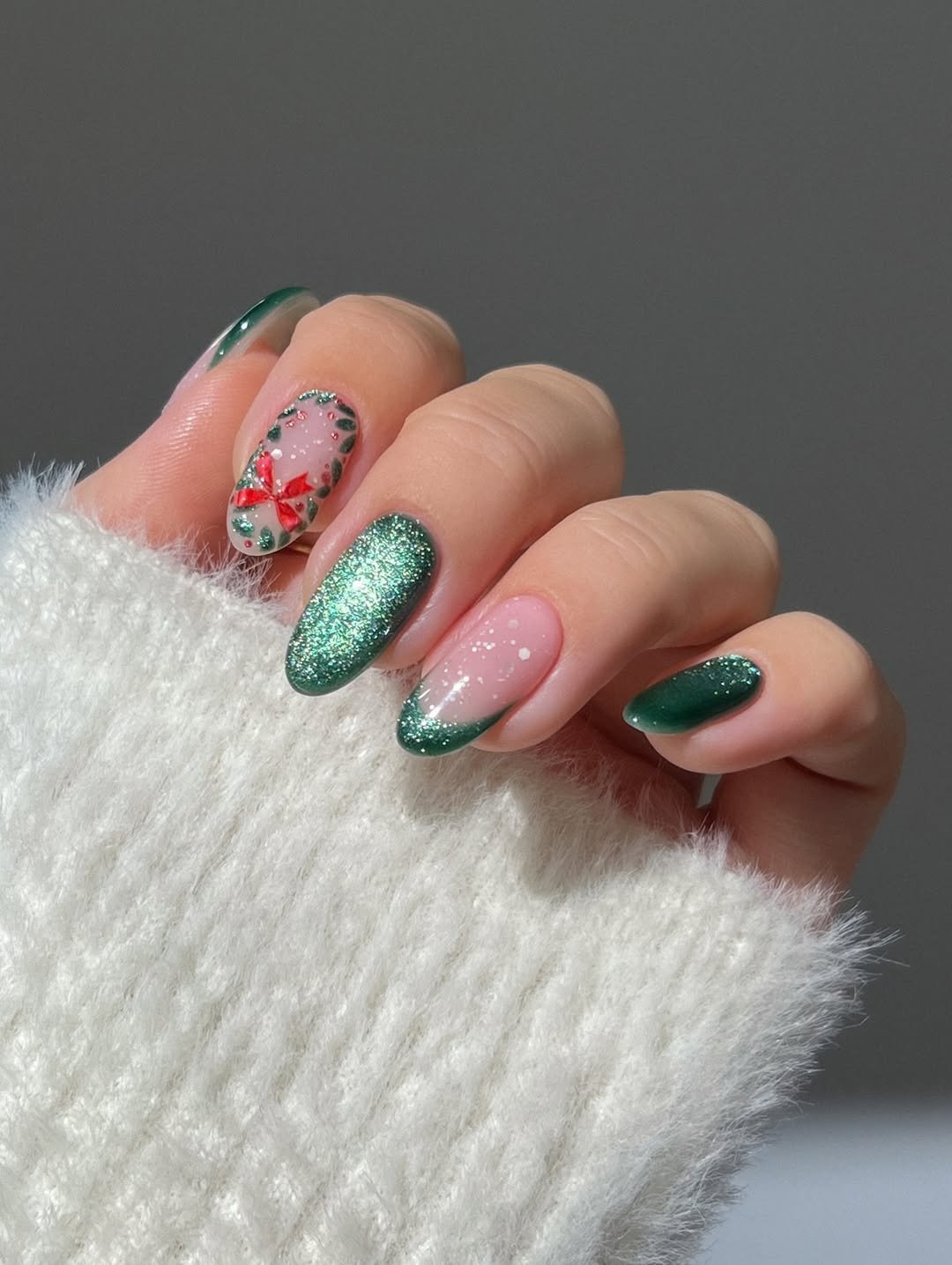 Green velvet nails, wreath nails, Christmas nails, holiday nails, emerald green nail inspo, sparkly nails glitter nails, cat eye nails, snowflakes nails, french tip nails, red bow nails, winter nails, gold marquise cut emerald ring, cluster diamond gold ring, Green glass nails , gold flake nails, classy simple nail:”s, jelly nails, curved gold diamond ring, almond nails, sparkly ombre nails, reflective glitter nails, gradient nails, pink nude nails,