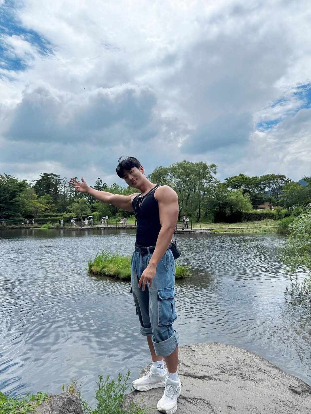 Photo by Jw on July 19, 2025. May be an image of 1 person, tanktop, lake, park and text.