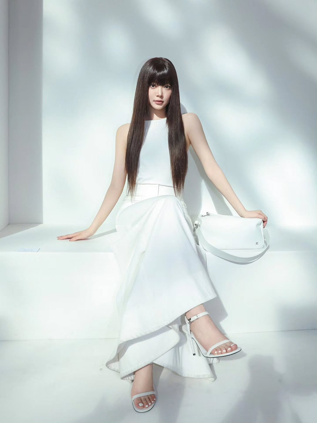 Photo shared by HONG EUNCHAE on March 04, 2026 tagging @courreges. May be an image of one or more people, makeup, hair, slingback shoes, dress and text.