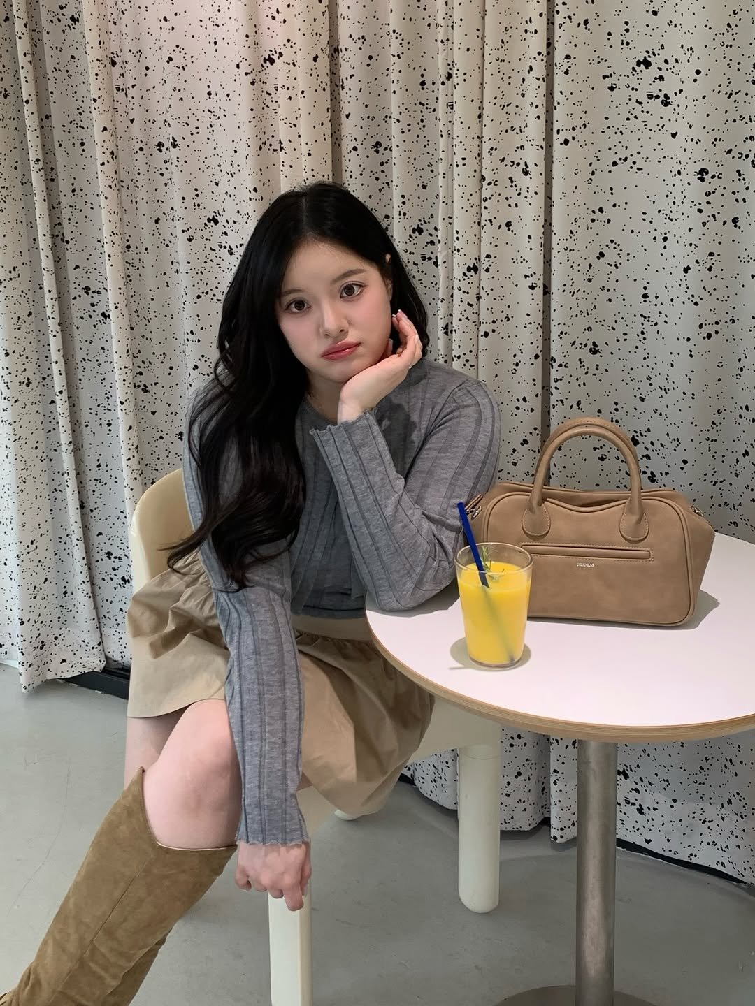 Photo by 물결 Mulgyul on April 11, 2026. May be an image of one or more people, hair, duffle coat, turtleneck, boots, purse, cornflower and text.