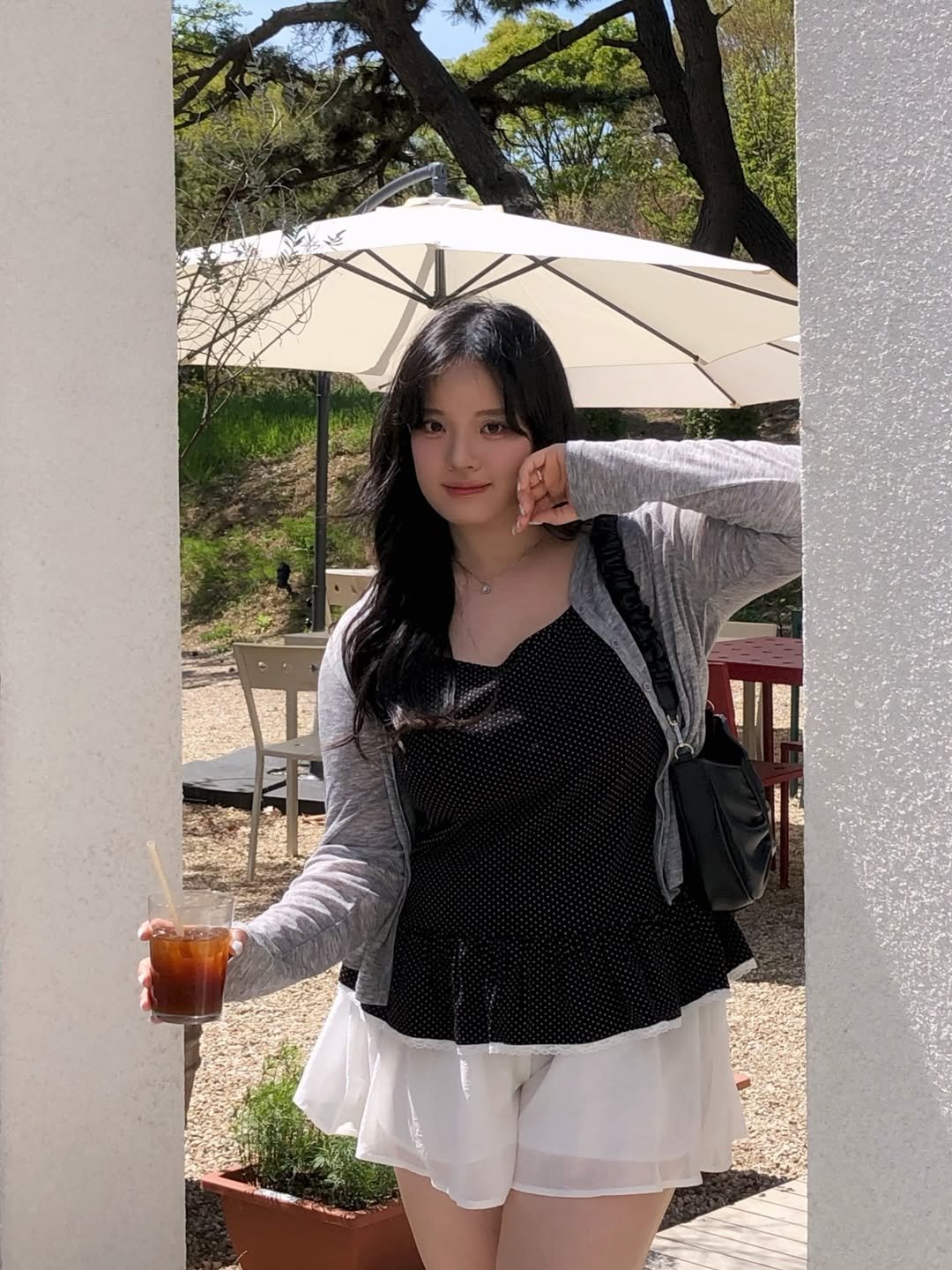 Photo by 물결 Mulgyul on April 26, 2026. May be an image of umbrella, parasol, miniskirt, sundress and text.