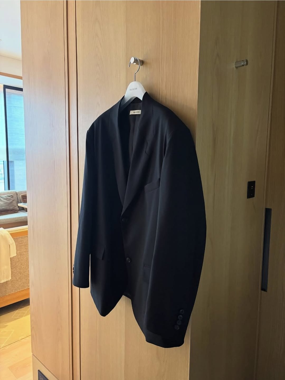 Photo by 남윤희 on March 19, 2026. May be an image of suit, coat rack, blazer, rack, dinner jacket, clothes hanger and text.