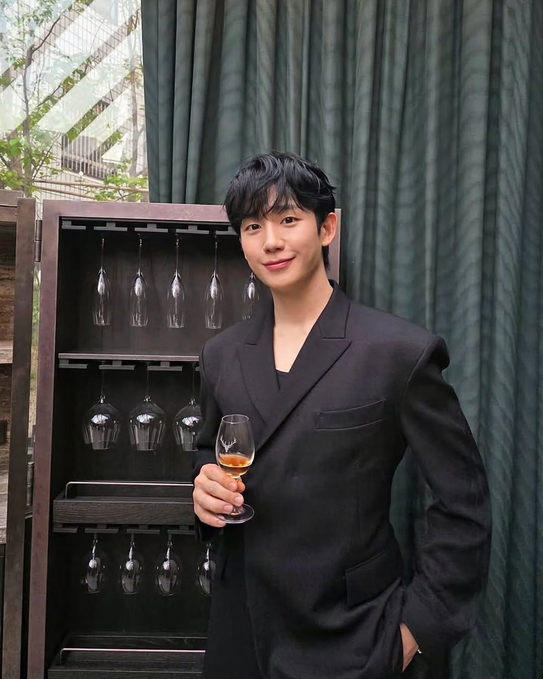 Photo shared by Happy HAEINESS on April 26, 2026 tagging @holyhaein. May be an image of drink, suit, blazer, dinner jacket, bolo tie and text.