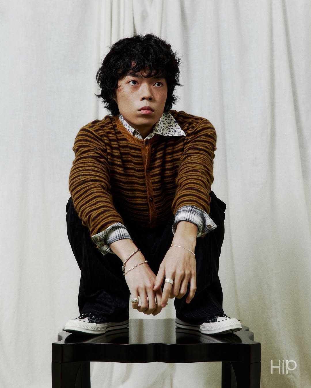 Photo shared by 에이치아이피 HIP on December 22, 2025 tagging @o3ohn. May be an image of one or more people, makeup, bolo tie, magazine, turtleneck and text.