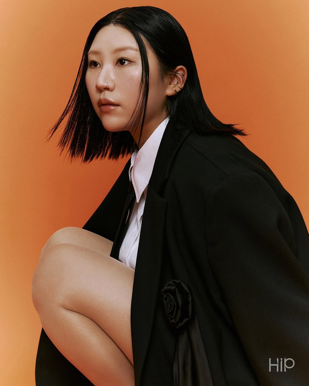 Photo shared by 에이치아이피 HIP on November 07, 2025 tagging @ooonthedal. May be an image of one or more people, hair, makeup, duffle coat, overcoat, bolo tie and text.