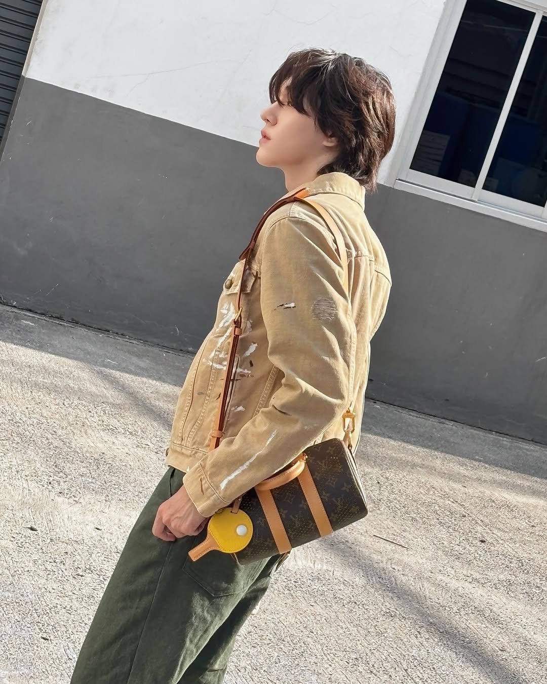 Photo shared by 「 Nani 」 on April 27, 2026 tagging @louisvuitton. May be an image of duffle coat, saddle-stitched leather, tool bag, military uniform, purse and text.