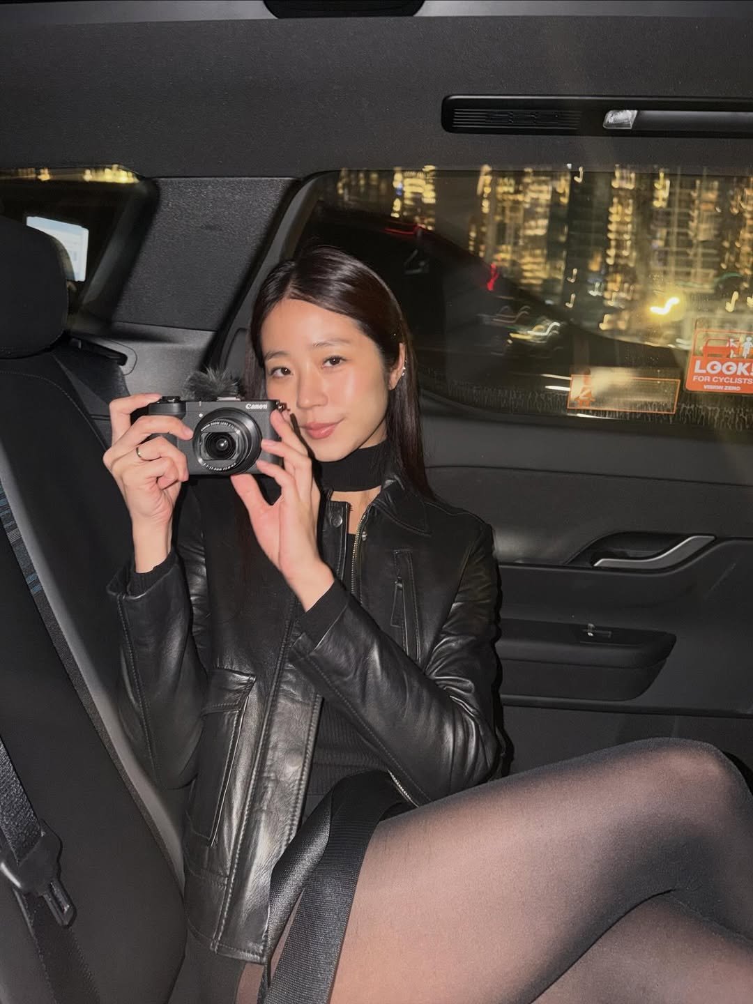 Photo shared by Evelyn 현정 Ha on February 11, 2026 tagging @canonusa. May be an image of leather, tights, miniskirt, fishnet stockings, limousine and text.