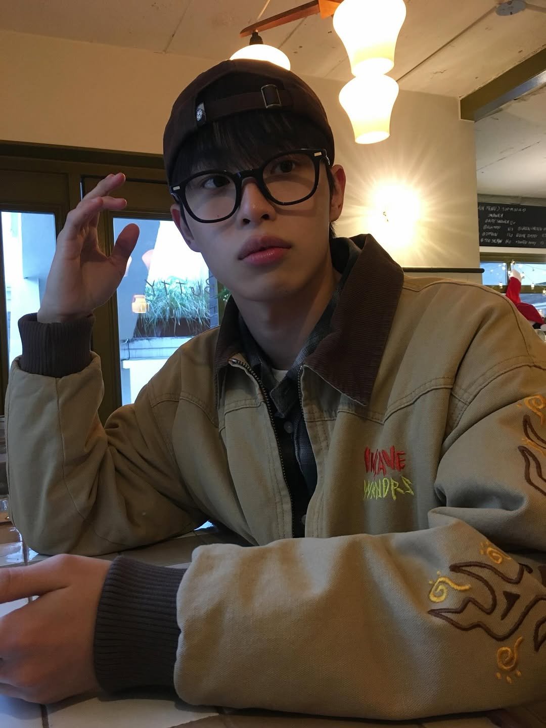 Photo by 정호균 on December 02, 2025. May be an image of eyeglasses, duffle coat and text.