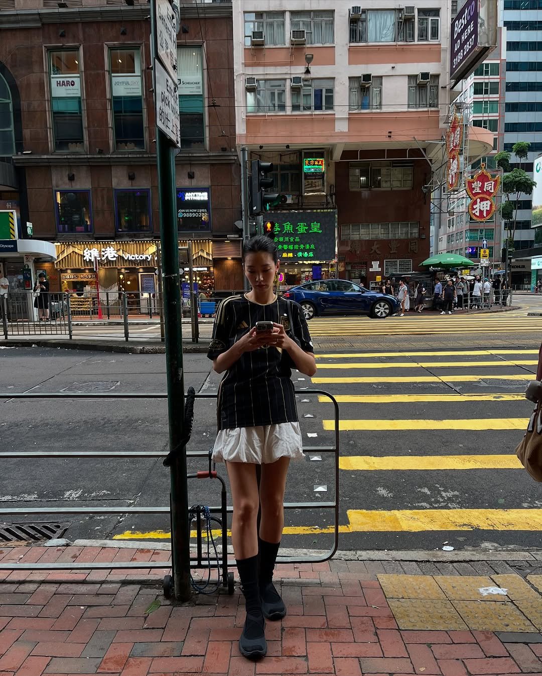 Photo shared by HOLLY 이호정 on September 30, 2025 tagging @lafc. May be an image of sparrow, parking meter, manhole, umbrella, miniskirt, street and text.