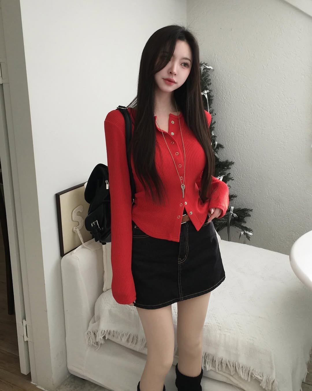 Photo by (주)홀리 on January 10, 2026. May be an image of one or more people, hair, turtleneck, skirt, top, sweater, miniskirt, dress and text.