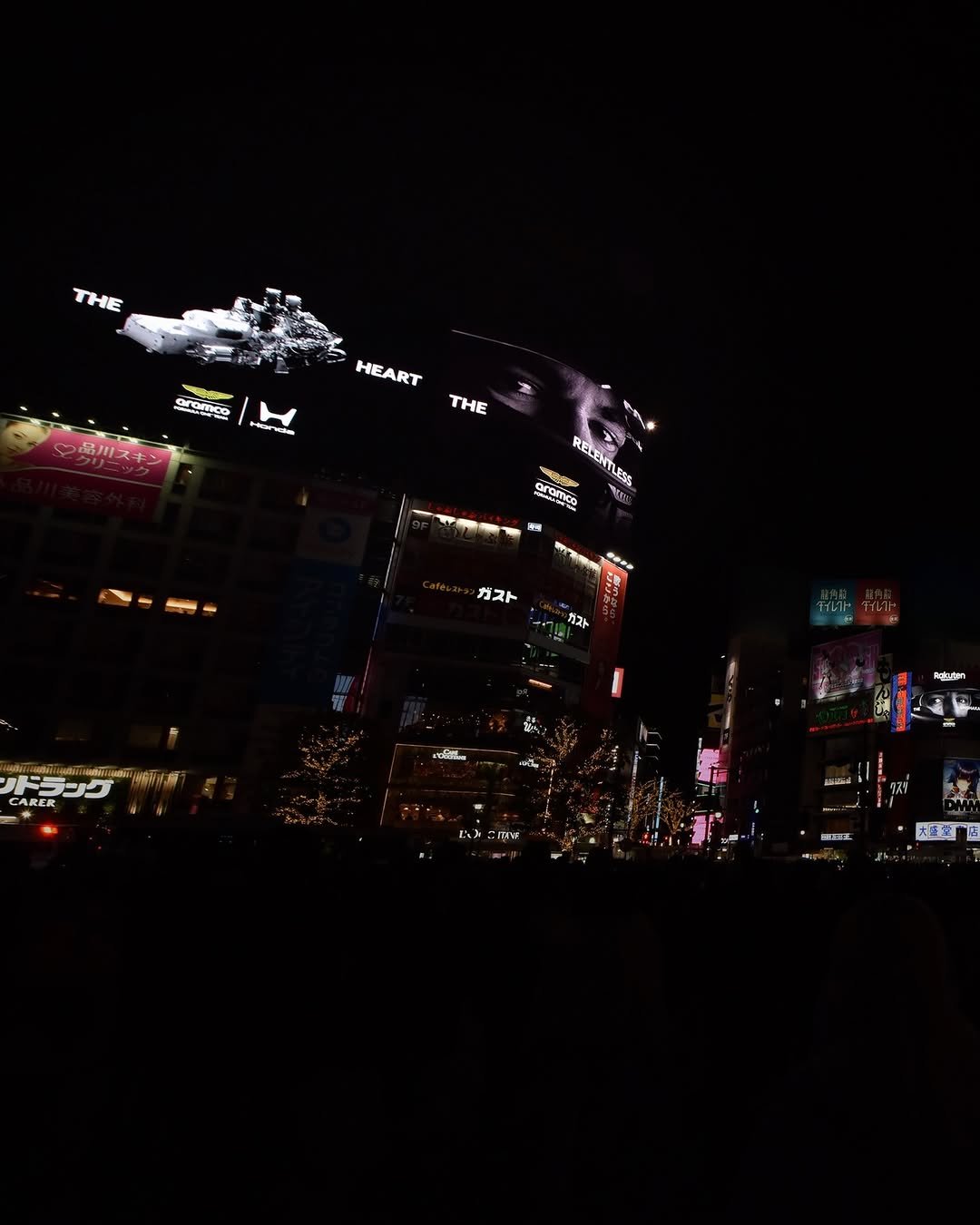 Photo shared by Aston Martin Aramco Formula One™ Team on February 13, 2026 tagging @hondaracingf1. May be an image of crocodile, crowd, night and text.