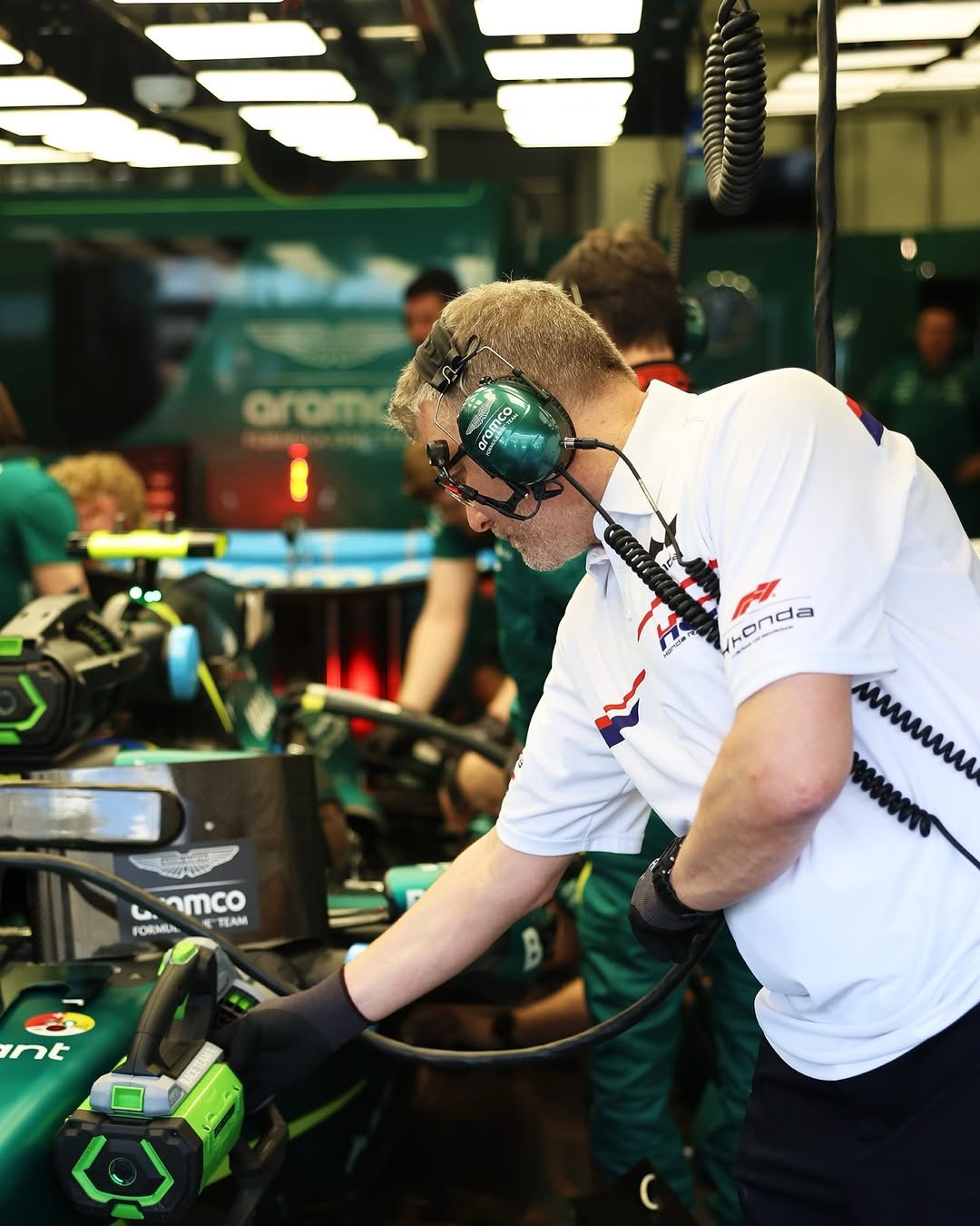 Photo shared by Honda Racing F1 on February 13, 2026 tagging @astonmartinf1, @hondaracingcorporation, and @hondaracingglobal. May be an image of racing vehicles, lawnmower, helmet, chainsaw and text.