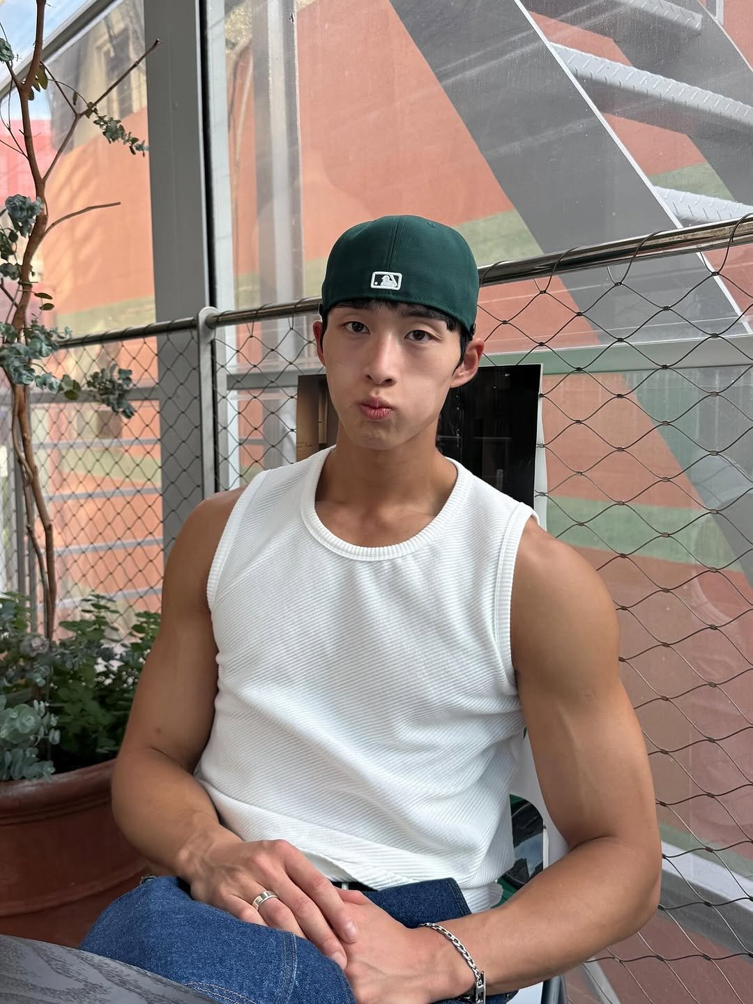 Photo shared by 홍버즈 on August 12, 2025 tagging @yune.kr. May be an image of 1 person, biceps, hat, tanktop and text.