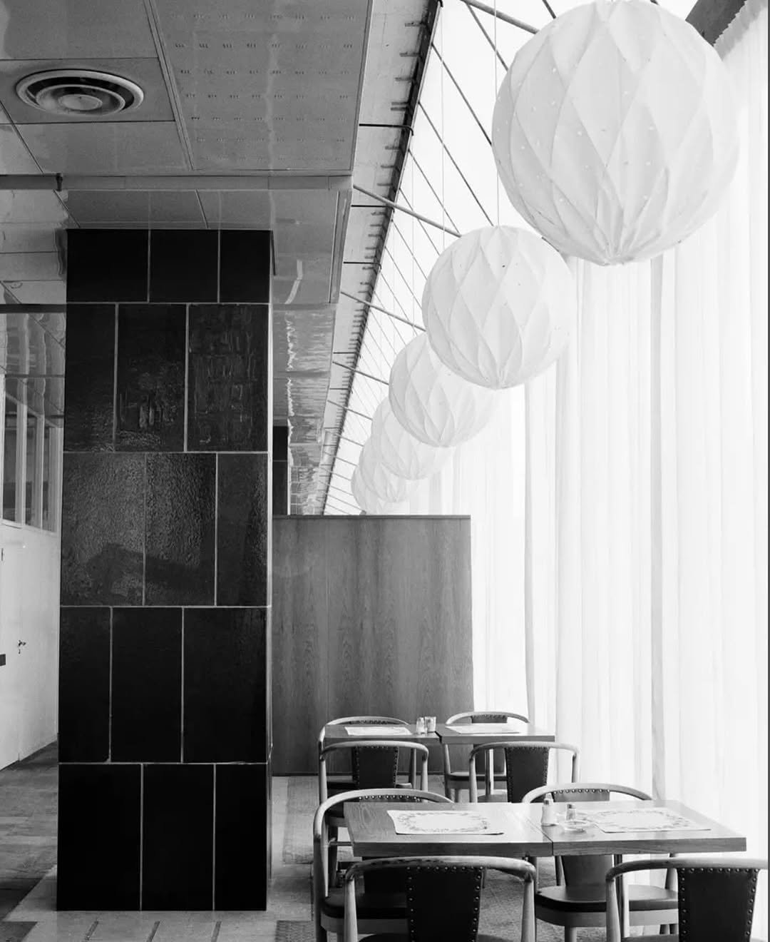 Photo by HPIX 에이치픽스 on November 07, 2025. May be a black-and-white image of lighting, indoors, office, hallway and text.