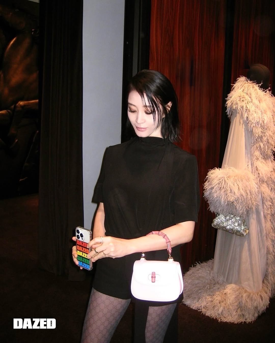 Photo shared by 김혜수 Hye Soo Kim on September 28, 2025 tagging @gucci, @stylist_boo, @hearts_ultrapeku, and @hyelim.jo. May be an image of 1 person, makeup, purse, miniskirt, fishnet stockings, tights and text that says 'DAZE E BAZETI DAZED'.