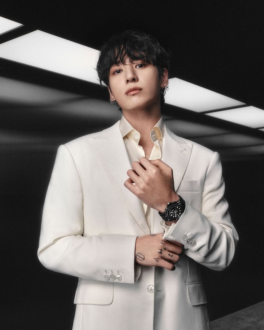 Photo shared by Hublot on March 11, 2026 tagging @mnijungkook. May be an image of one or more people, bangs, bolo tie and text.