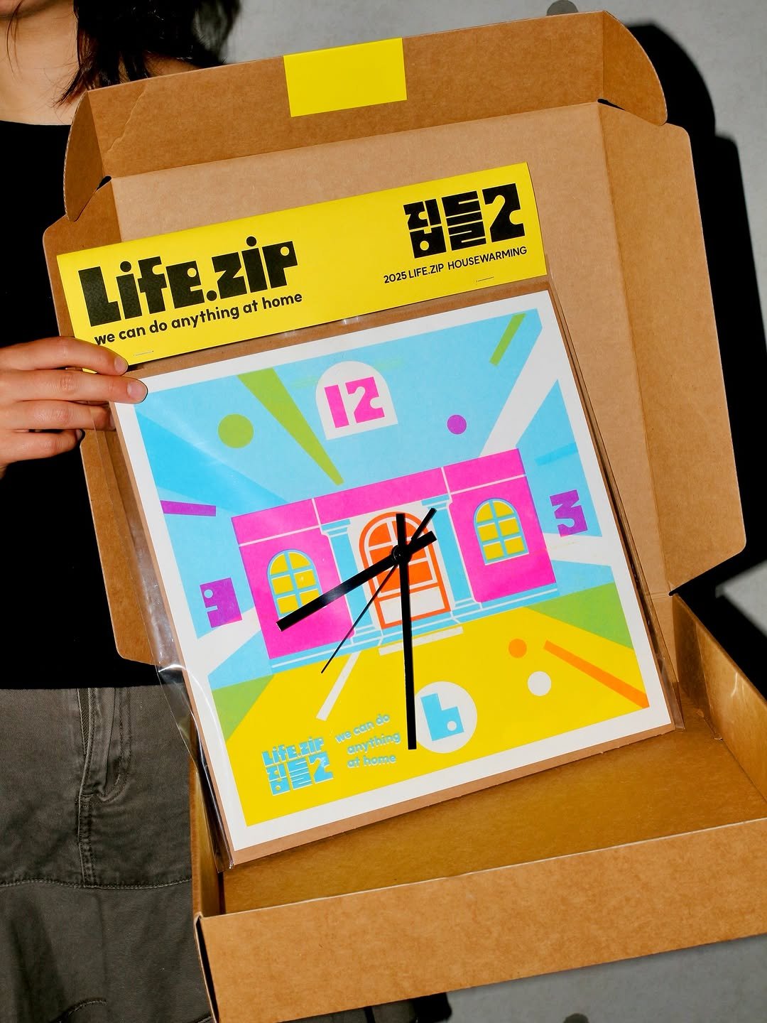 Photo shared by 하우풀리소클럽 HWFRISOCLUB on July 08, 2025 tagging @lifezip_kr, and @hwf.edition. May be pop art of 1 person, poster, timer, box, calendar, carton and text that says '잠들2 HOUSEW HOUSEWARMING WARMING 2025L 2025LIFE.ZIP Life.zir any anything at home we can do 12 如国3 生 3 can LİfE.ZİF ក2 at anything athome'.
