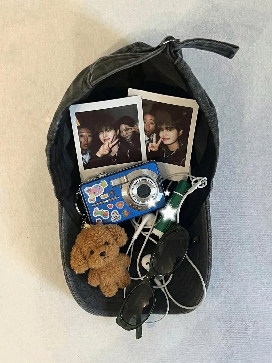 Photo shared by 이대휘 LEE DAEHWI on March 01, 2026 tagging @marcellasne_, and @captain_gon. May be an image of polaroid, purse, portable cassette player, pouch, pencil case and text.