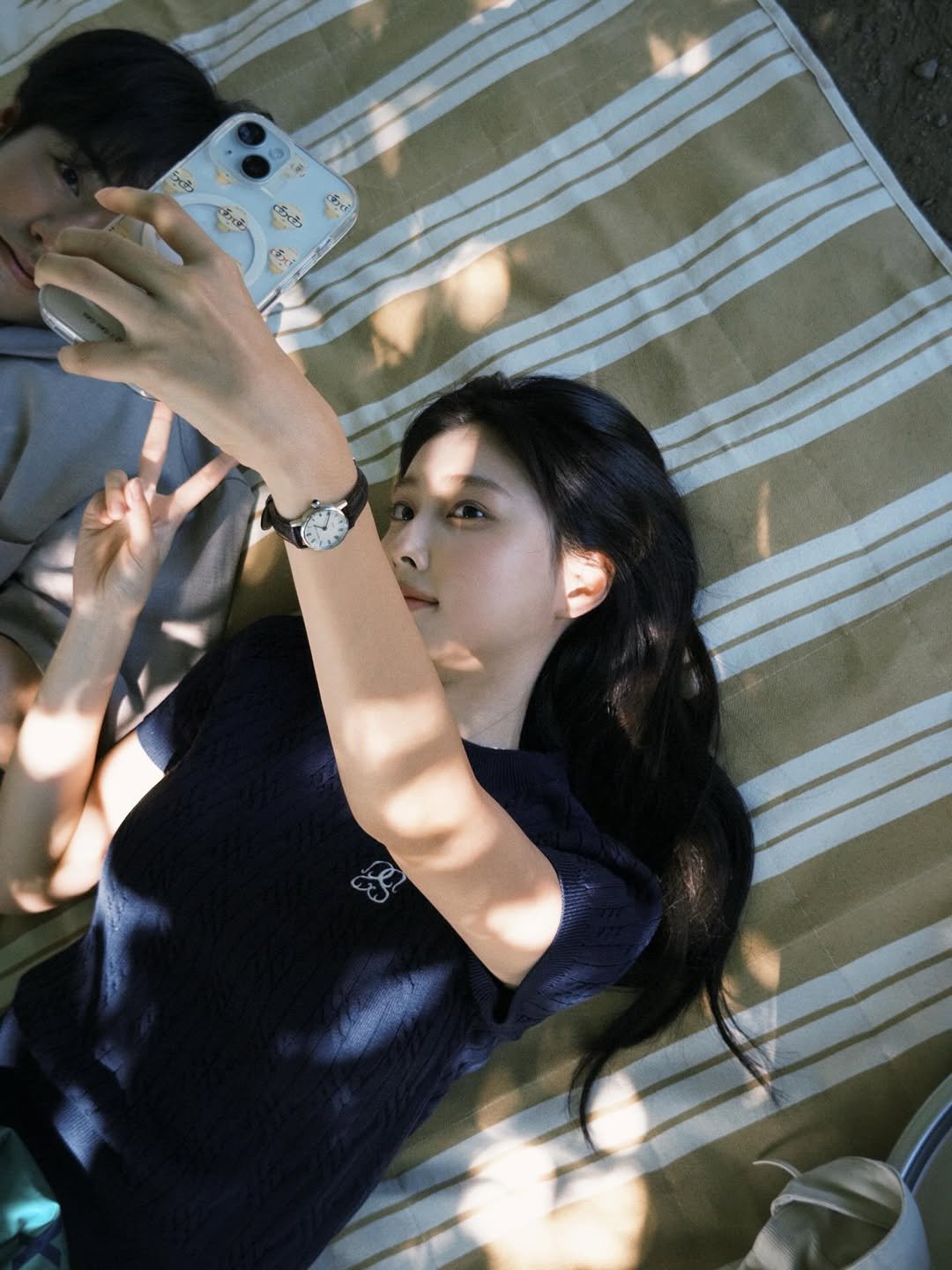 Photo shared by 강혜원 Kang hyewon on February 20, 2026 tagging @tx_premiere23. May be an image of one or more people, hair, phone, picnic and text.