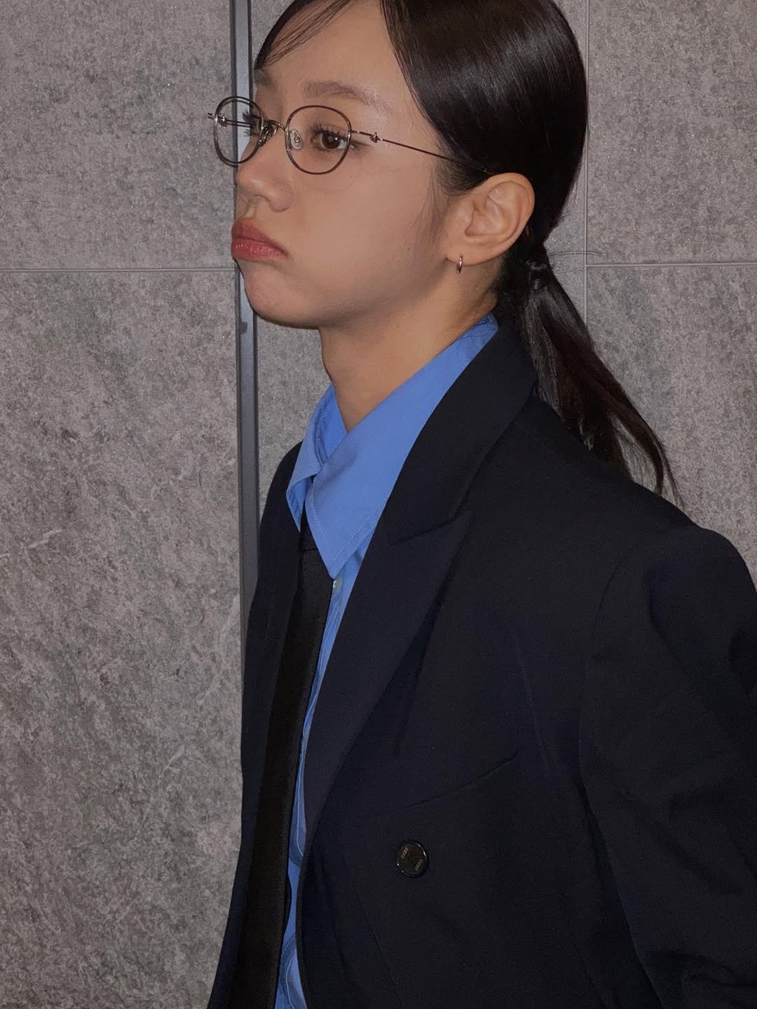 Photo shared by 혜리 on October 31, 2025 tagging @dabang_app. May be an image of one or more people, hair, duffle coat, eyeglasses, blazer, suit and text.