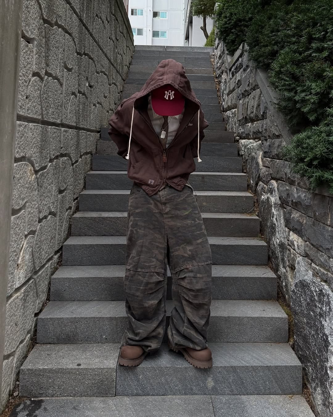 Photo by 황혁 on December 08, 2025. May be an image of duffle coat, scarecrow, cloak, costume, parka, face mask and military uniform.