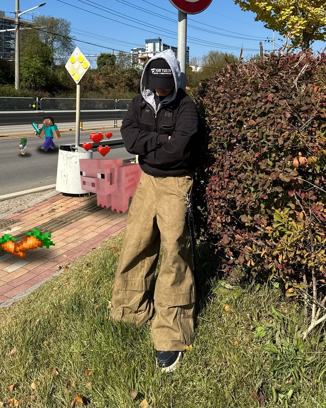 Photo by 황혁 on February 16, 2026. May be an image of standing, face mask, scarecrow, gas mask, street, curb and telephone pole.