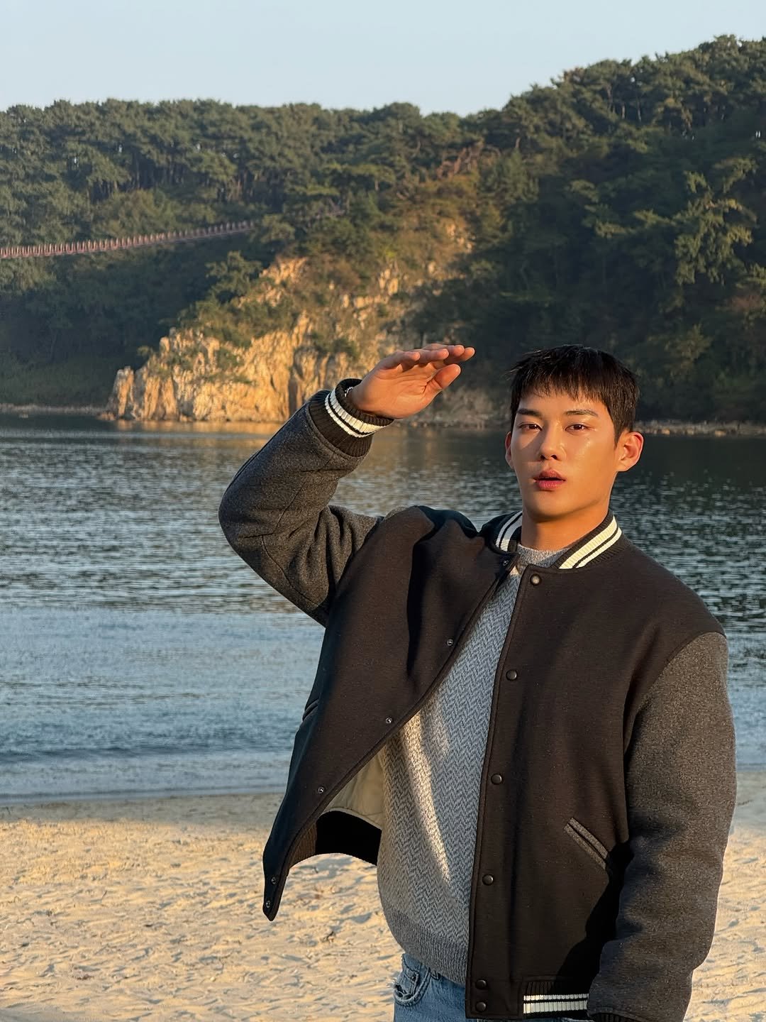 Photo by 기현우 on March 14, 2026. May be an image of one or more people, jacket, beach, ocean and text.