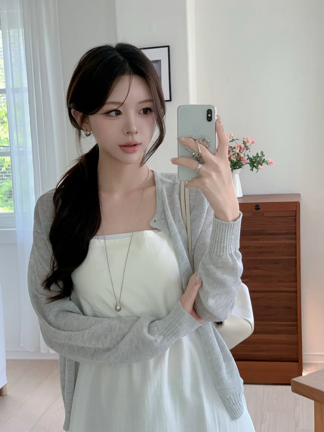 Photo by 정이네 데일리룩 l 정이🎀 on April 23, 2026. May be an image of one or more people, hair, top, cardigan, dress, white lily and text.