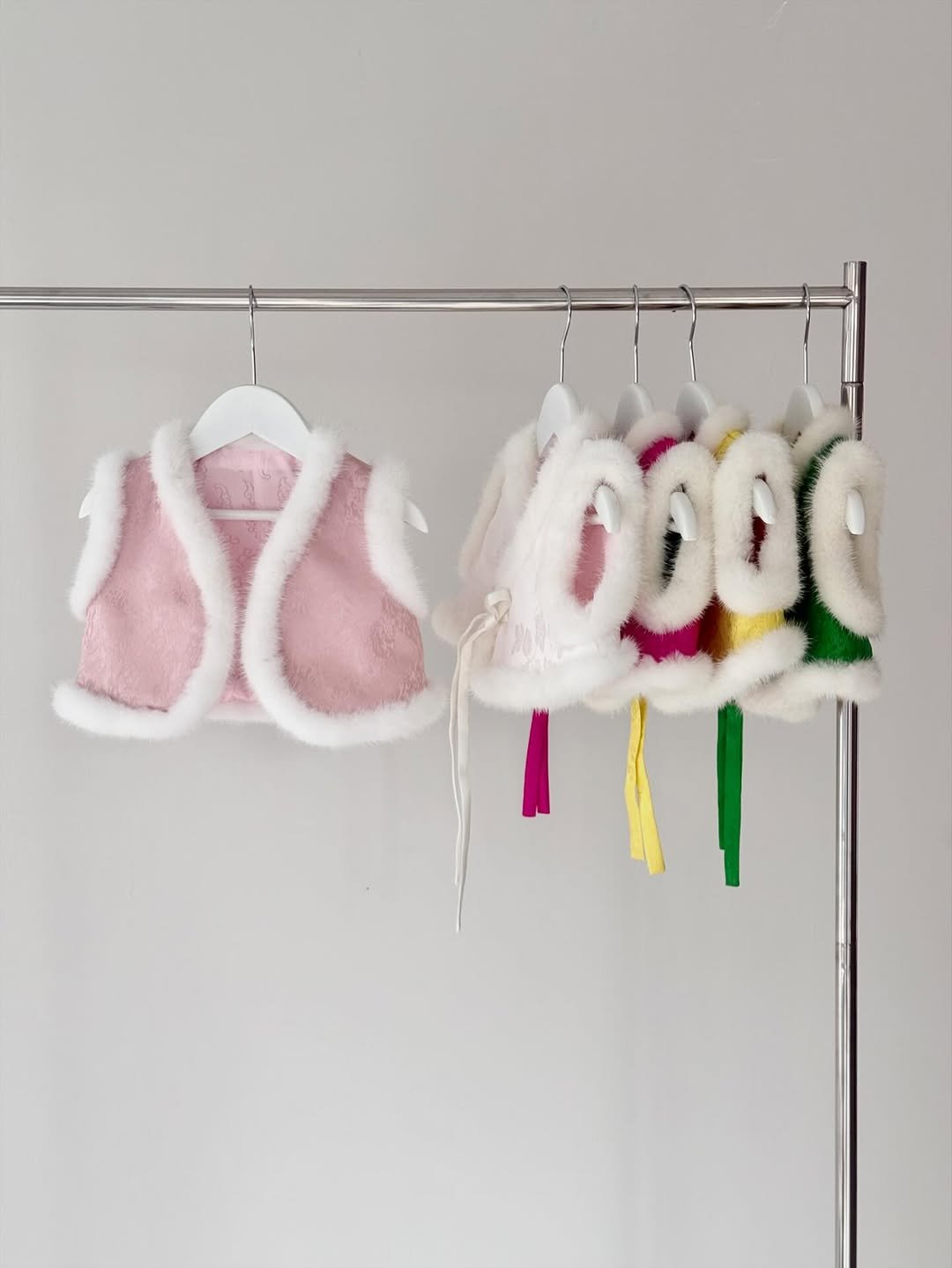 Photo by 이아한복 | 돌한복 백일한복 돌상 백일상 on January 27, 2026. May be an image of fur, clothes hanger, baby shoes, rack and text.