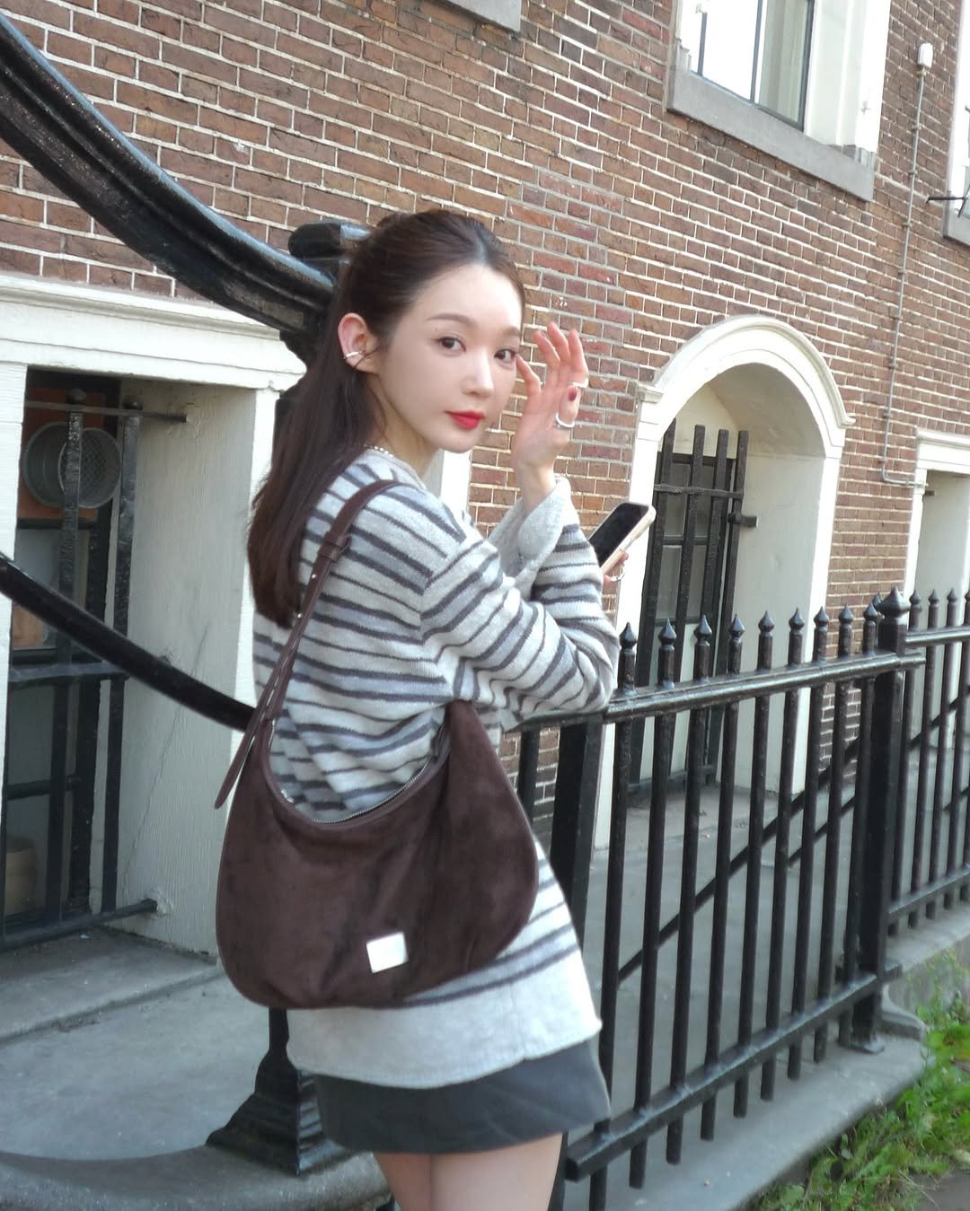 Photo shared by 강민경 (행동파) on August 28, 2025 tagging @marithe_kr. May be an image of 1 person, purse, miniskirt and text.