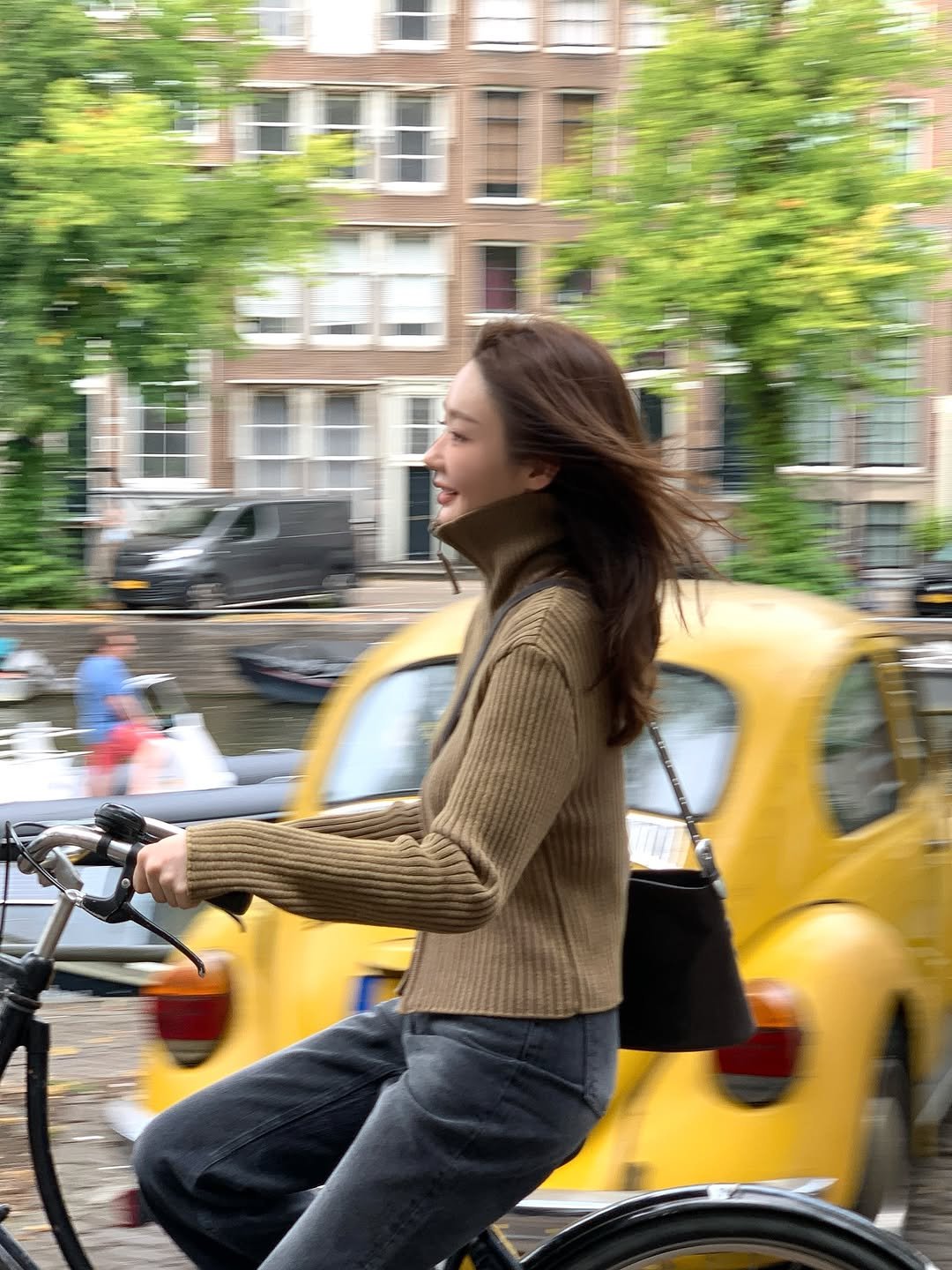 Photo shared by 강민경 (행동파) on August 26, 2025 tagging @aviemuah. May be an image of 1 person, bicycle, turtleneck, street and text.