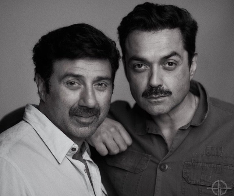 Photo shared by Sunny Deol on January 27, 2026 tagging @iambobbydeol. May be a black-and-white image of one or more people, beard, people smiling and text.