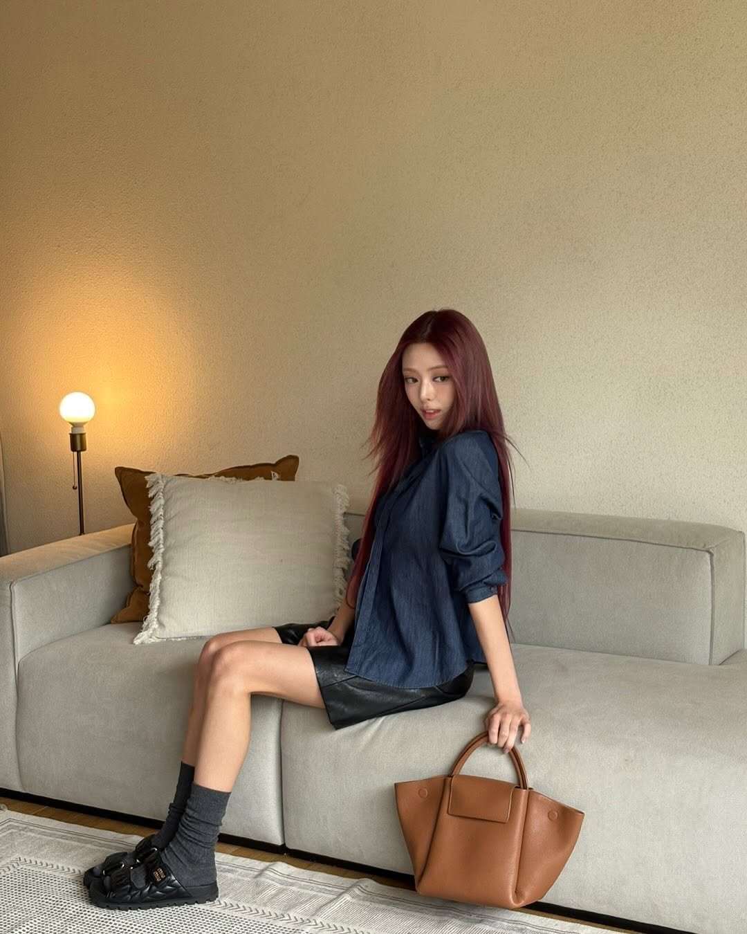 Photo by YUNA on September 03, 2025. May be an image of 1 person, leather, briefcase, purse, boots and text.