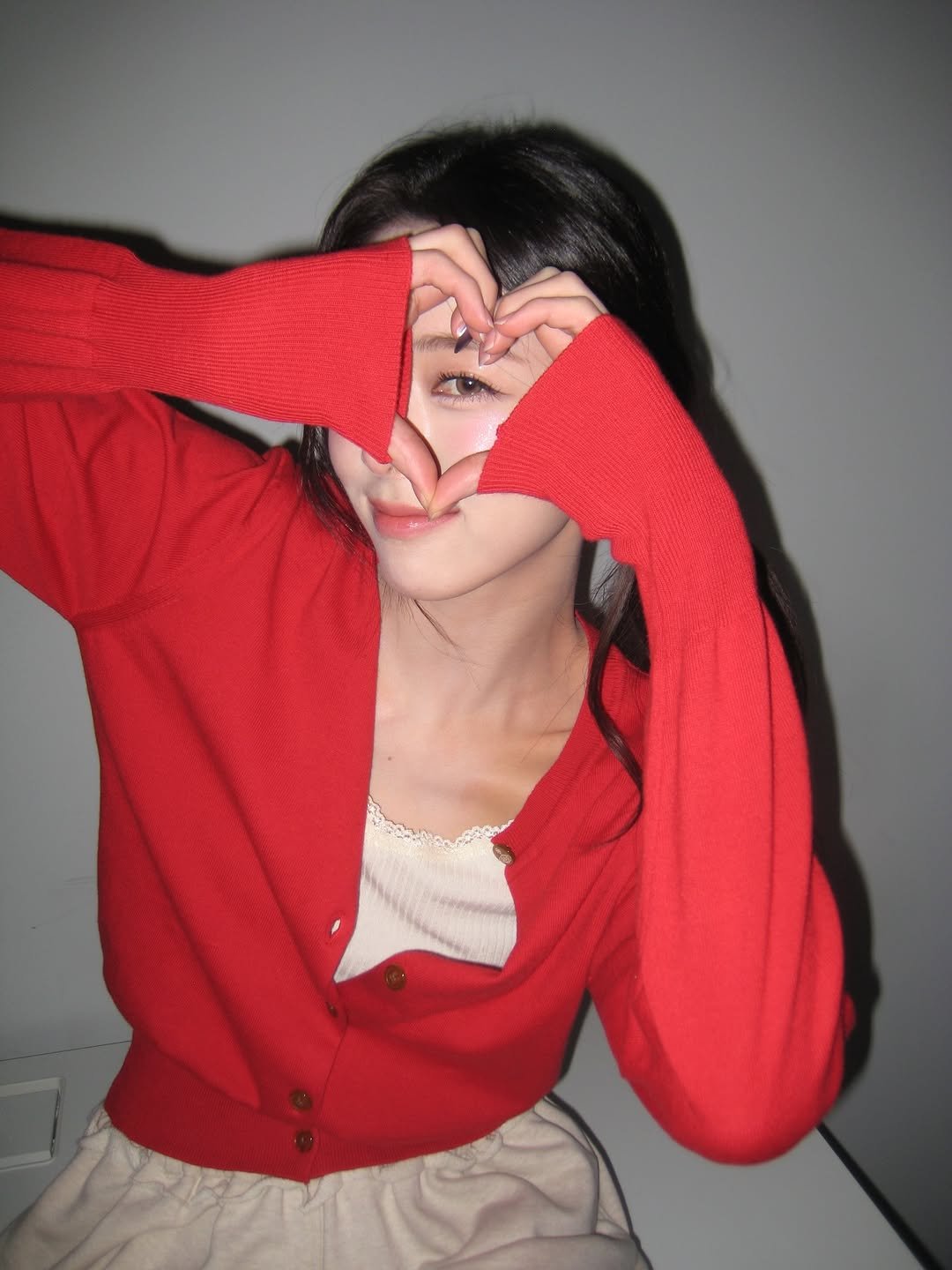 Photo by YUNA on December 25, 2025. May be an image of one or more people, hair, heart, sweater, top and text.